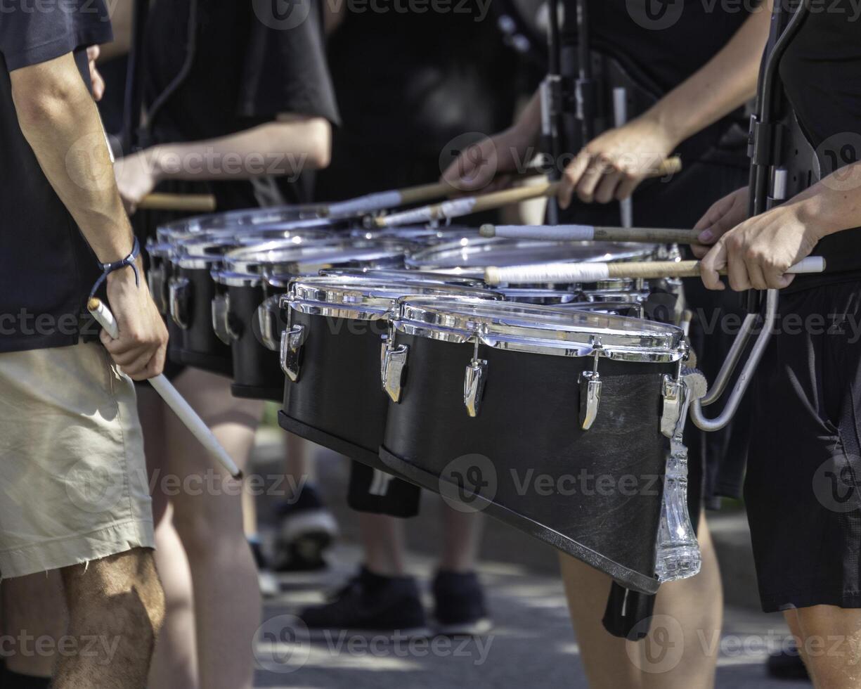 percussionists of a marching band drum line warming up for a parade photo