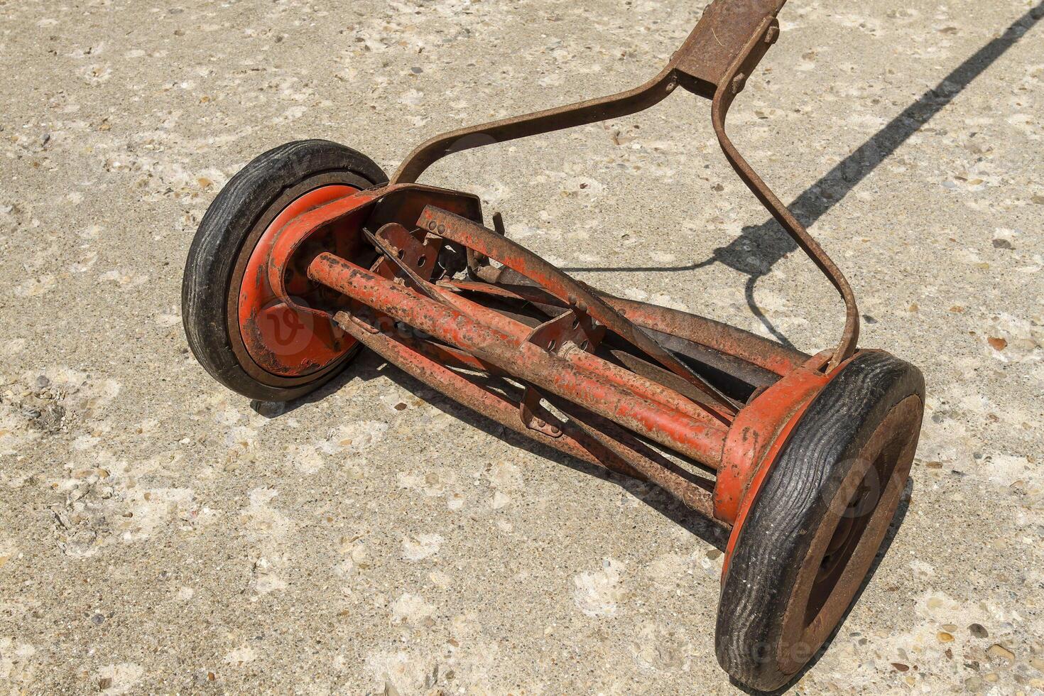 a close up view look at a reel lawnmower before the paint was removed photo
