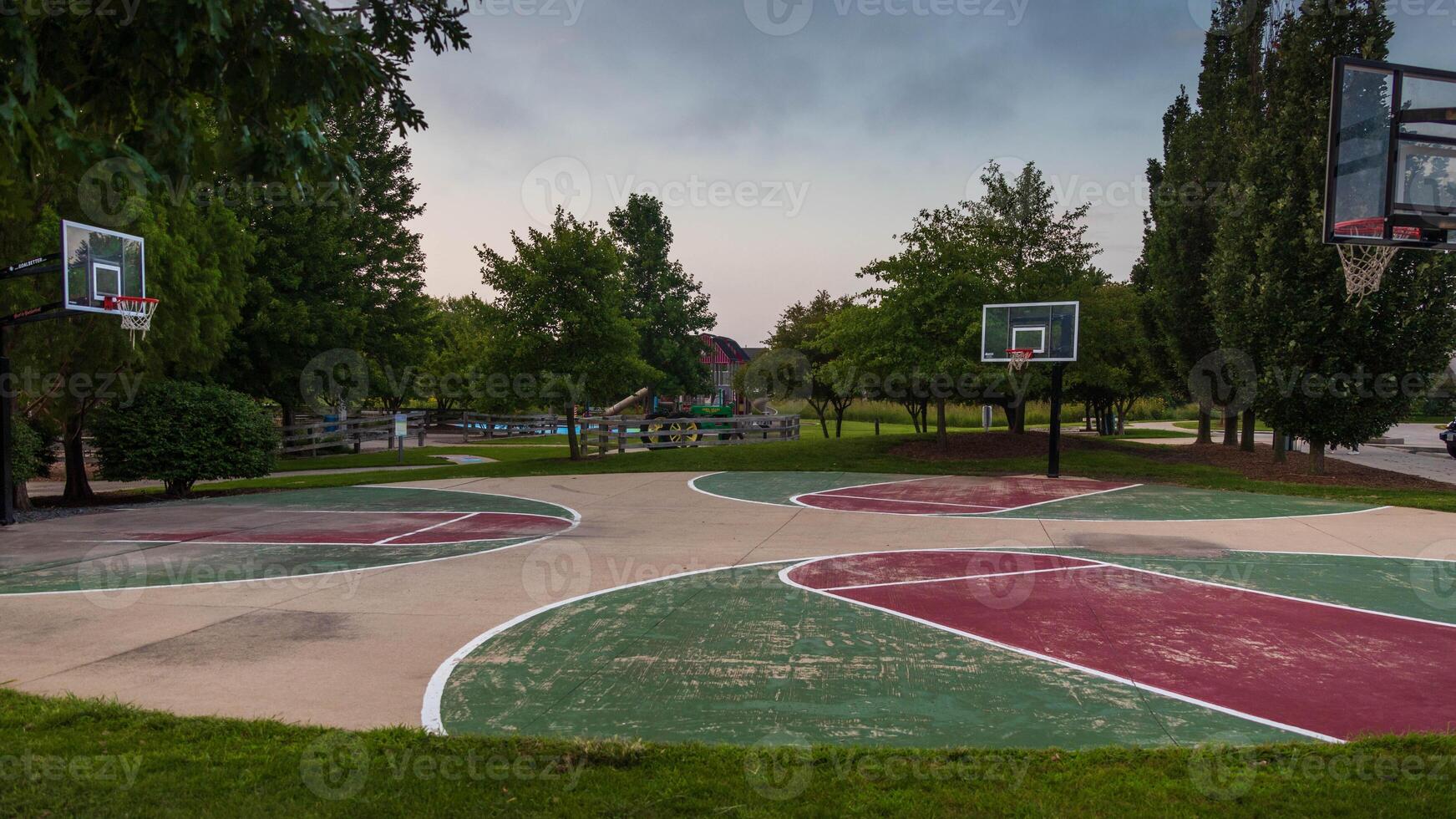 open basketball courts in a city park on a early morning photo