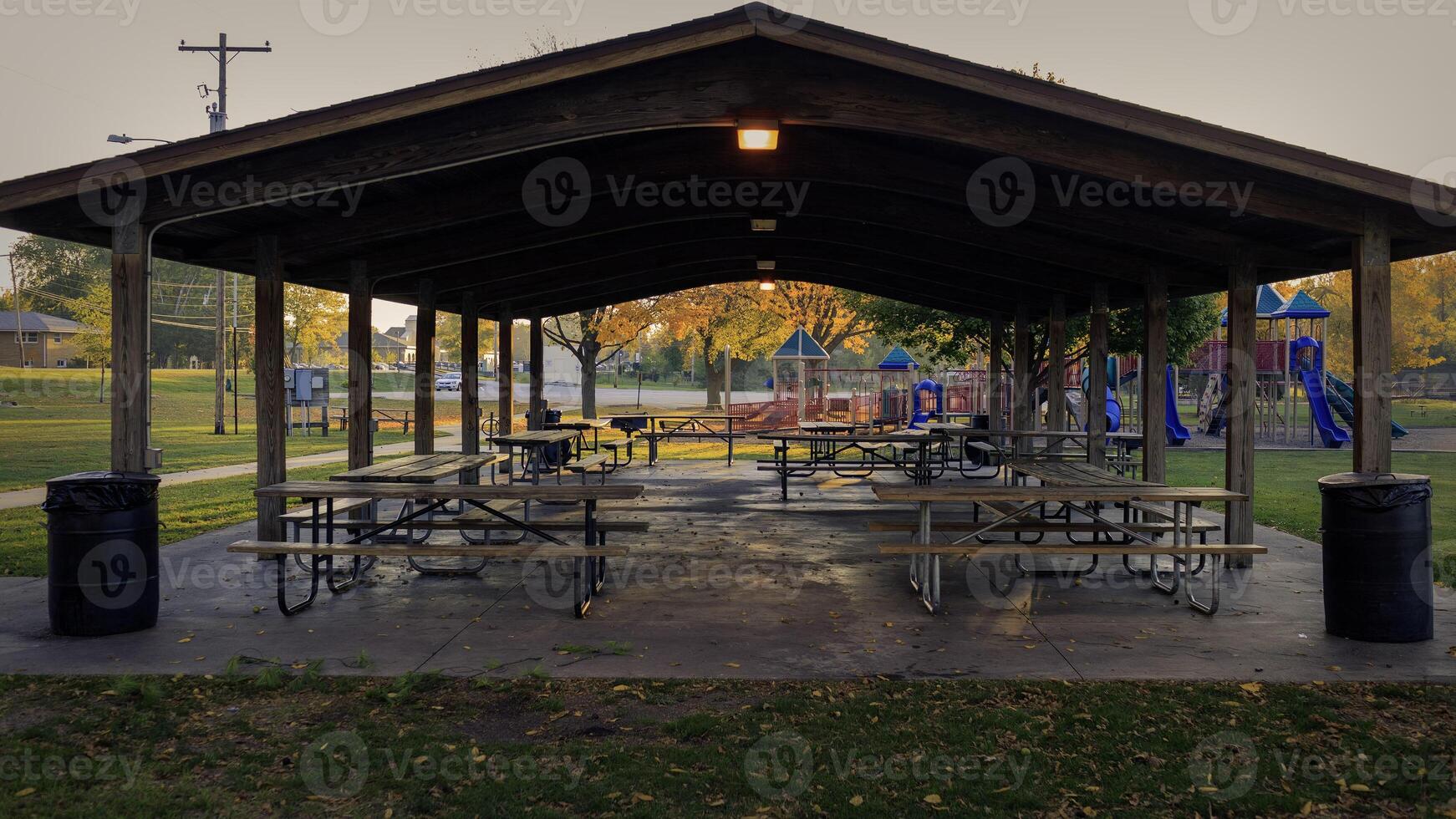 picnic tables in a pavilion are ready for the days gatherings on this summer morning photo