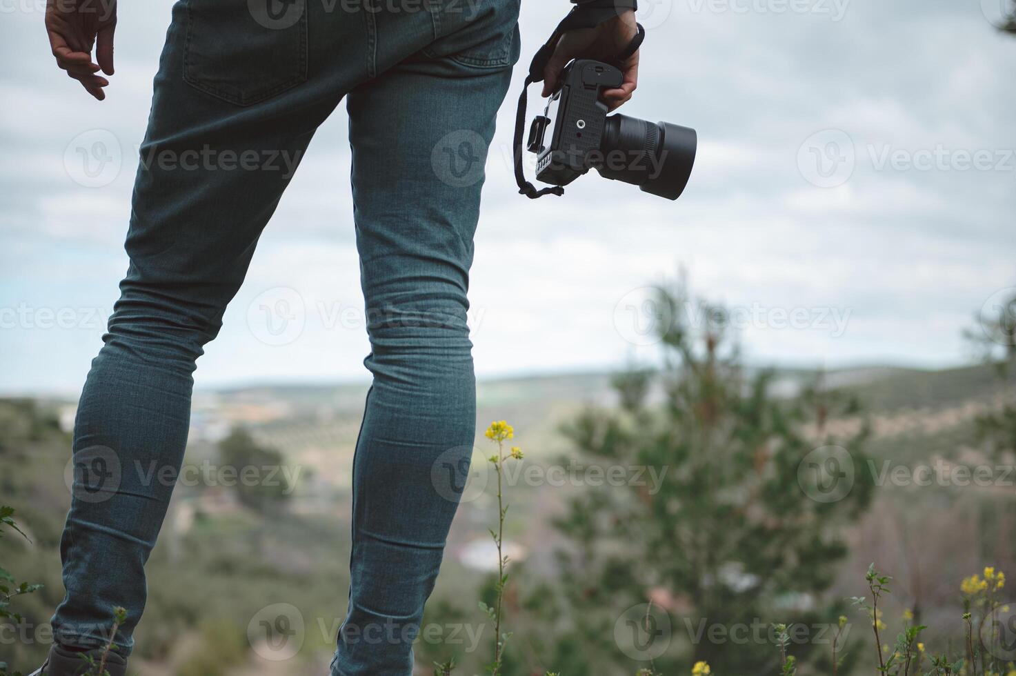 Close-up professional camera in the hands of male traveler photographer photo