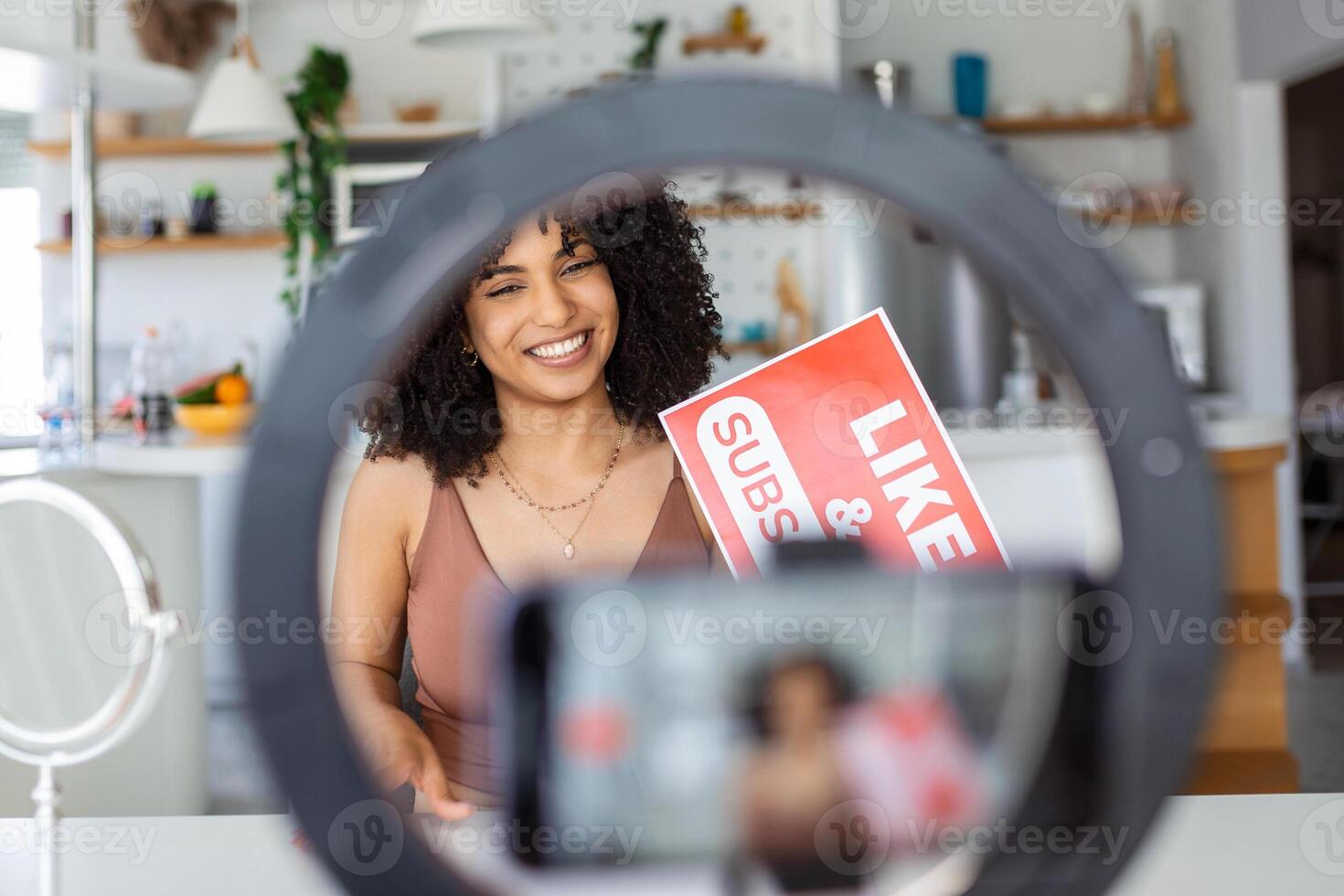 Female vlogger asking online audience to like and subscribe to her channel, daily videos photo