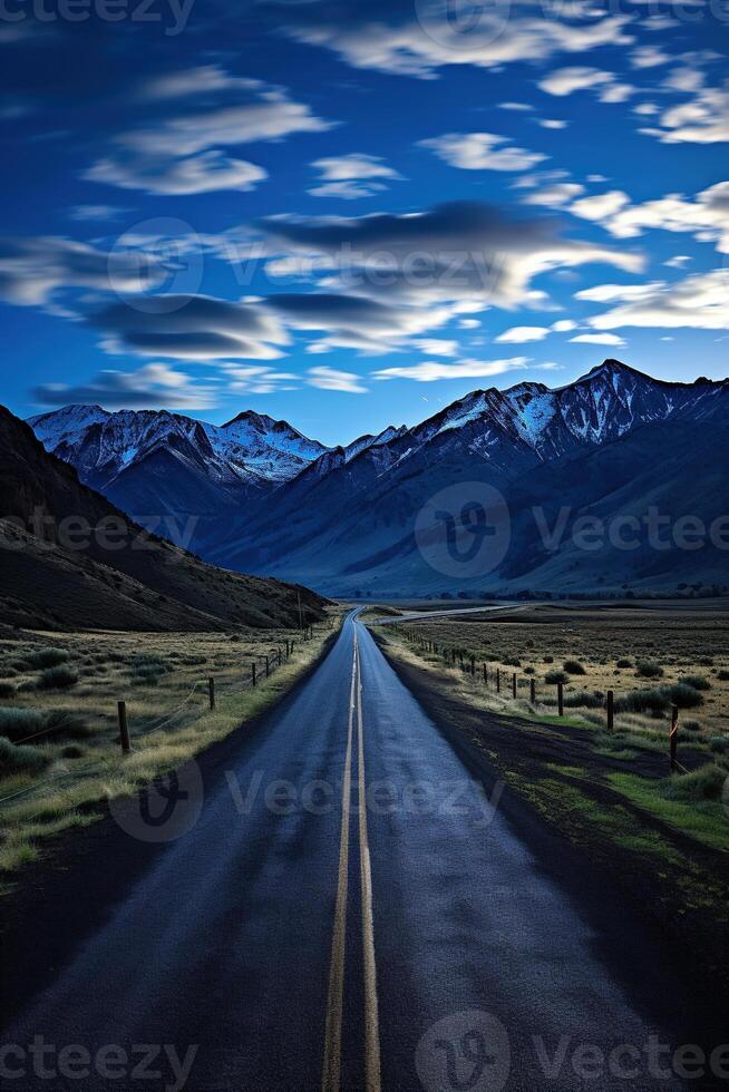 AI generated Beautiful vertical scenic view of a straight asphalt road after rain in a mountain valley under a cloudy sky photo