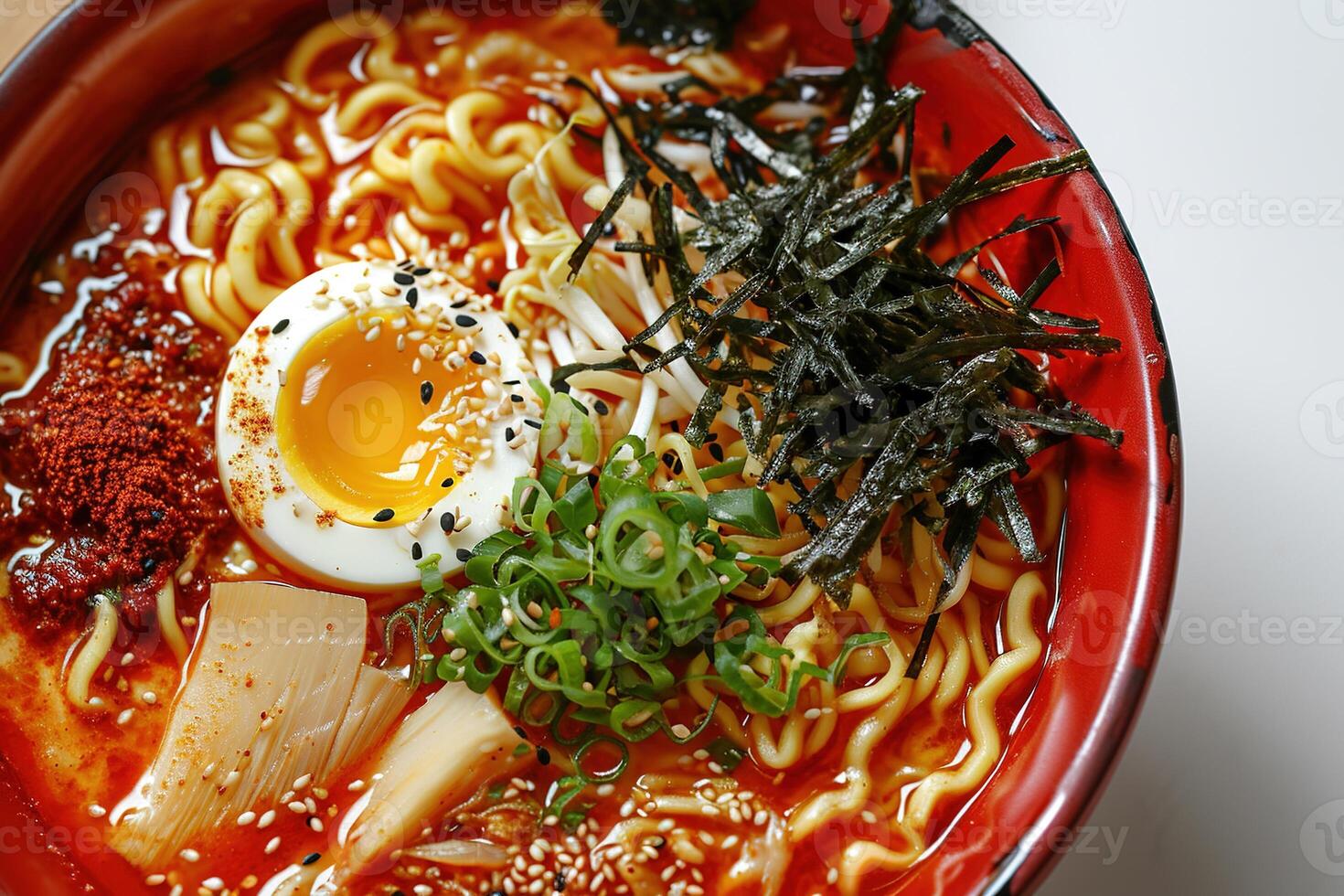 AI generated closeup red bowl of delicious ramen with kimchi on a white table, tasty traditional asian noodle soup top view photo