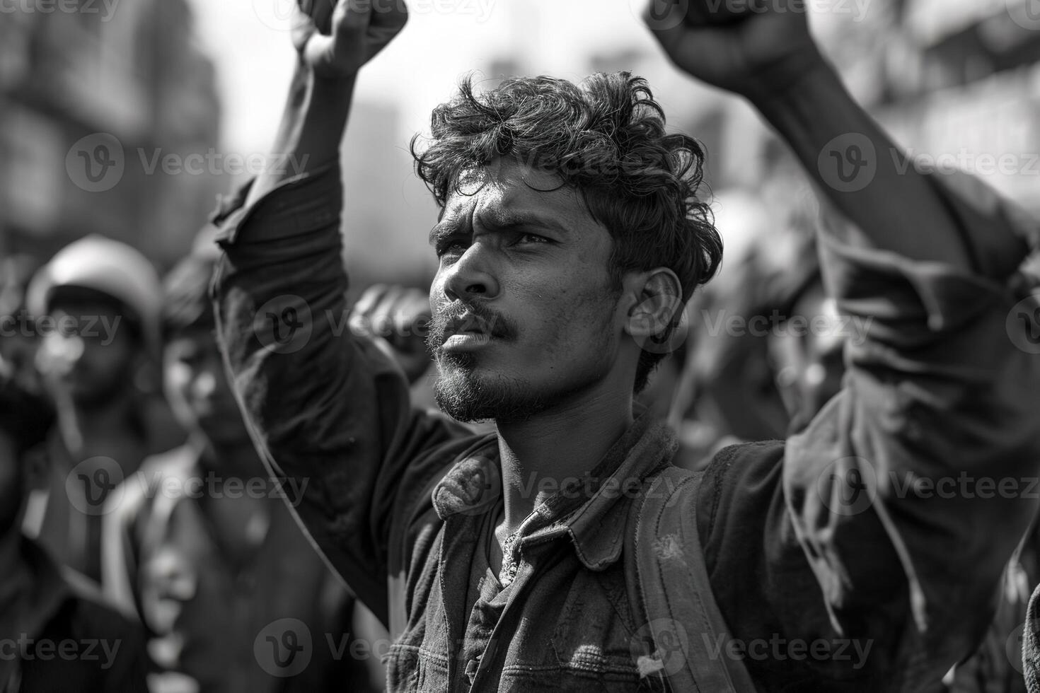 AI generated Black and white retro image of a young serious worker raising his hands in protest at a workers' rights rally photo