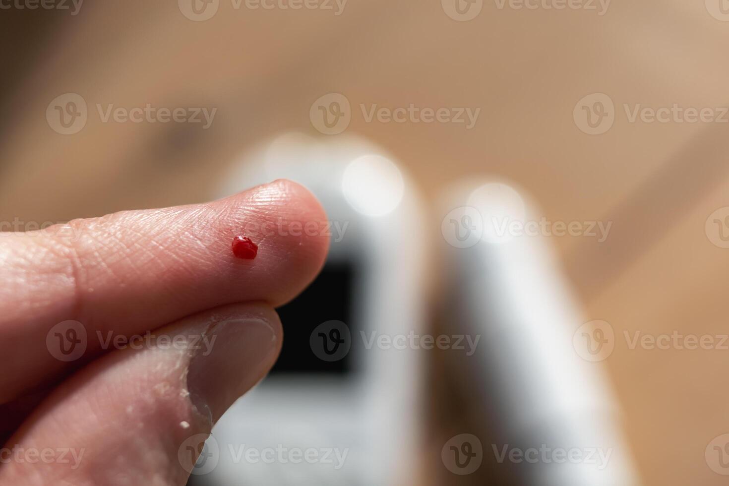 Woman pricking her finger to check blood glucose level with glucometer, test blood glucose for diabetes photo