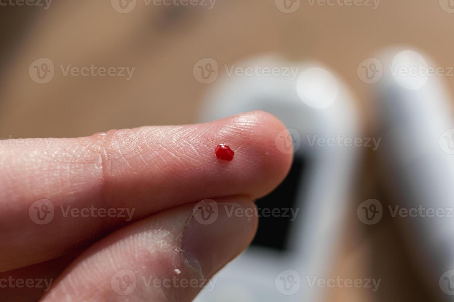 Woman pricking her finger to check blood glucose level with glucometer, test blood glucose for diabetes photo