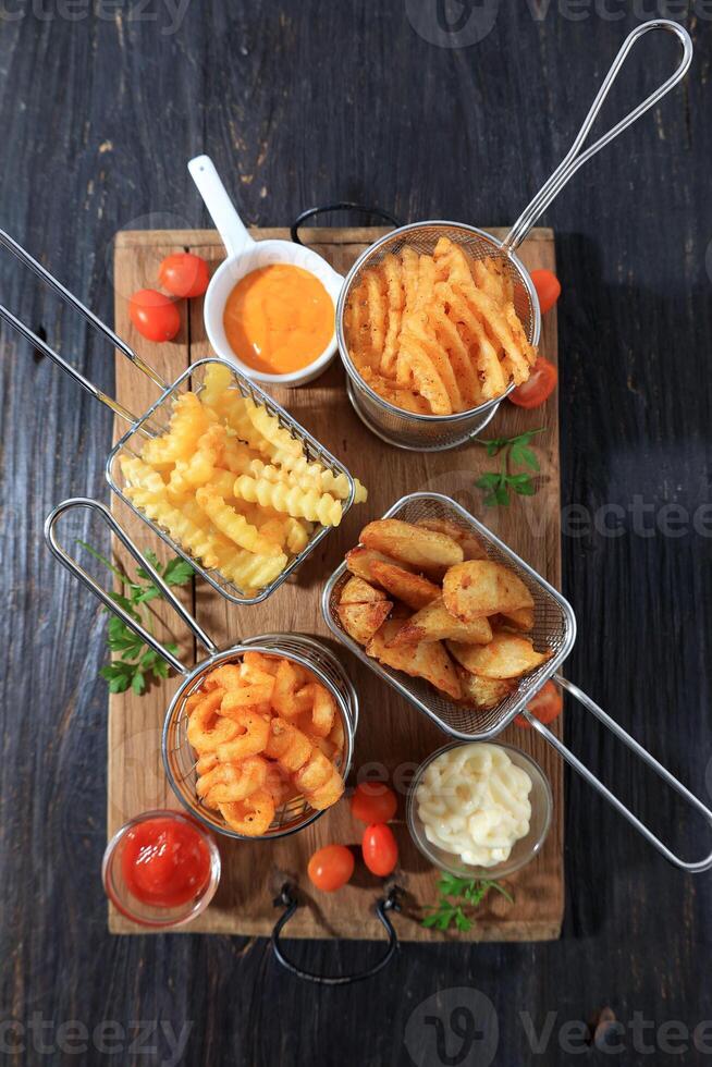Assorted French Fries and Chips in Metal Baskets photo