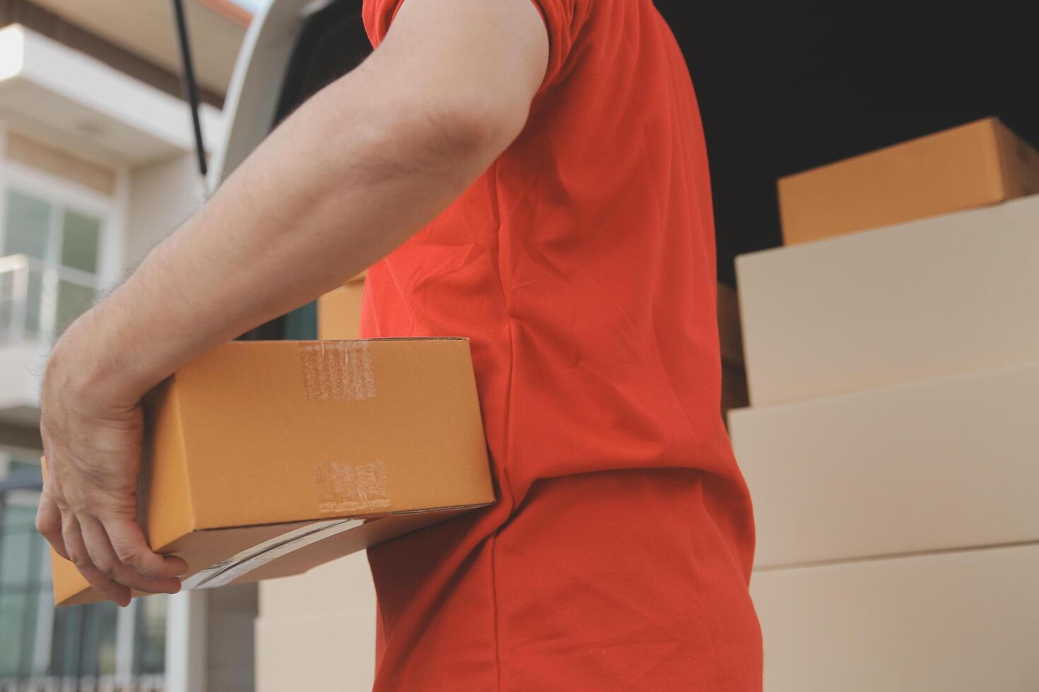 Asian delivery express courier young man use giving boxes to woman customer he wearing protective face mask at front home photo