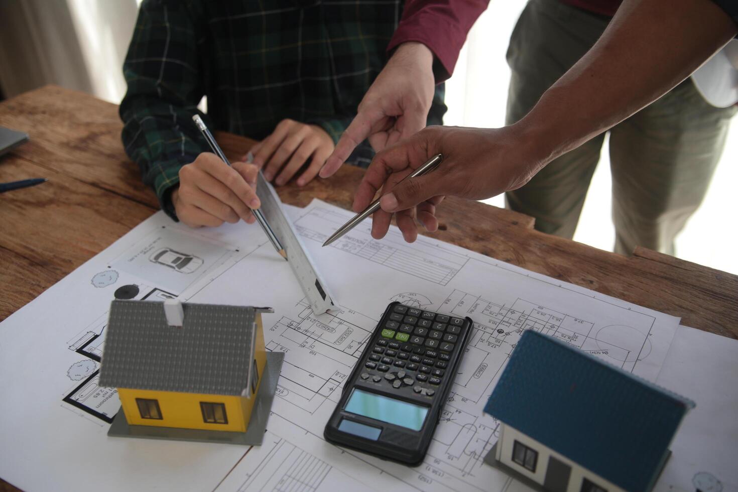 Diverse Team of Specialists Use Laptop on Construction Site. Real Estate Building Project with Engineer Investor and Businessman Checking Area, working on Civil Engineering, Discussing Strategy Plan photo