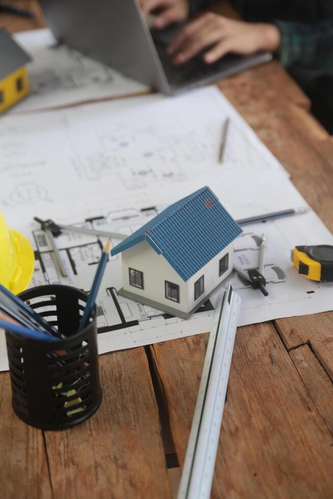 Diverse Team of Specialists Use Laptop on Construction Site. Real Estate Building Project with Engineer Investor and Businessman Checking Area, working on Civil Engineering, Discussing Strategy Plan photo