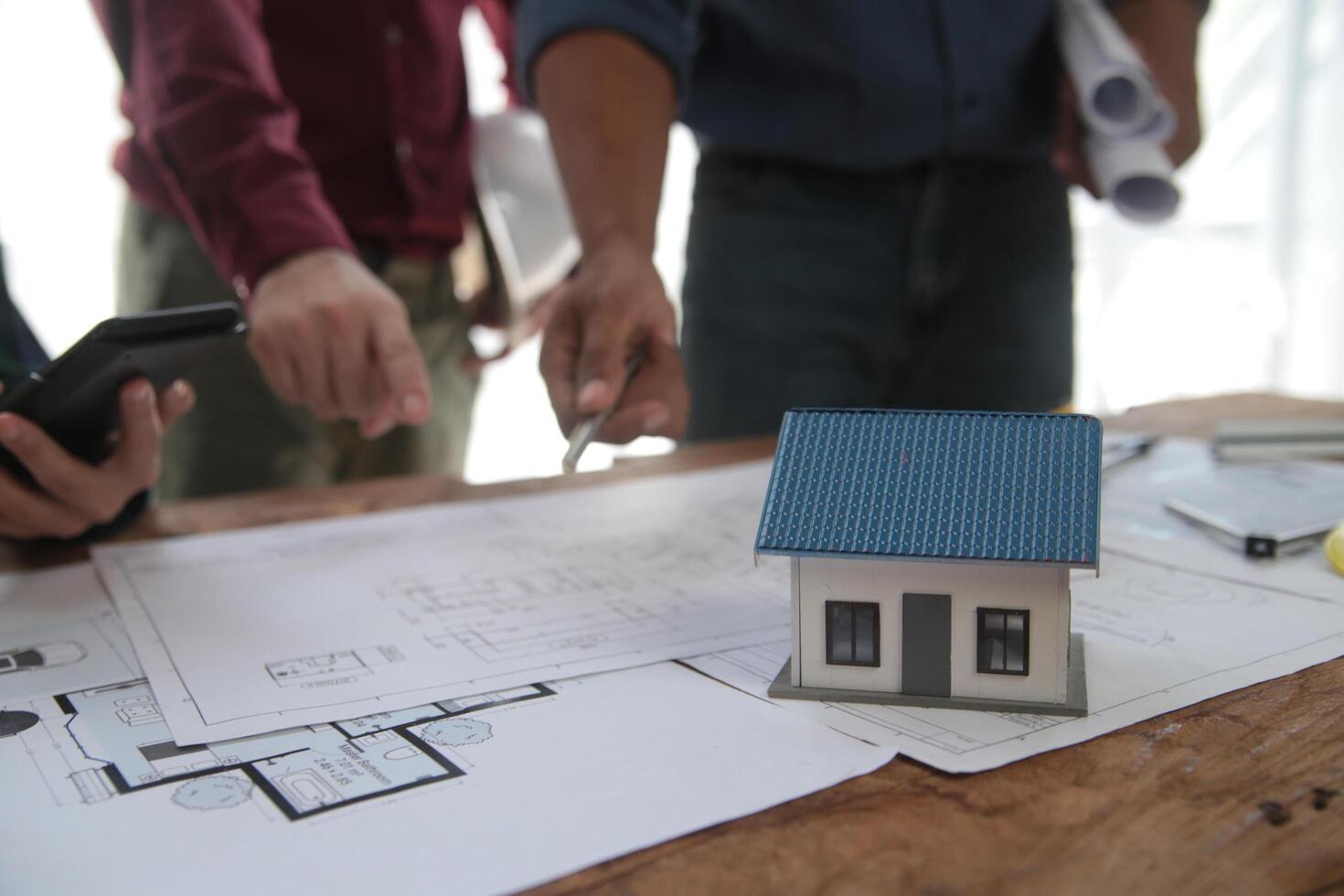 Diverse Team of Specialists Use Laptop on Construction Site. Real Estate Building Project with Engineer Investor and Businessman Checking Area, working on Civil Engineering, Discussing Strategy Plan photo