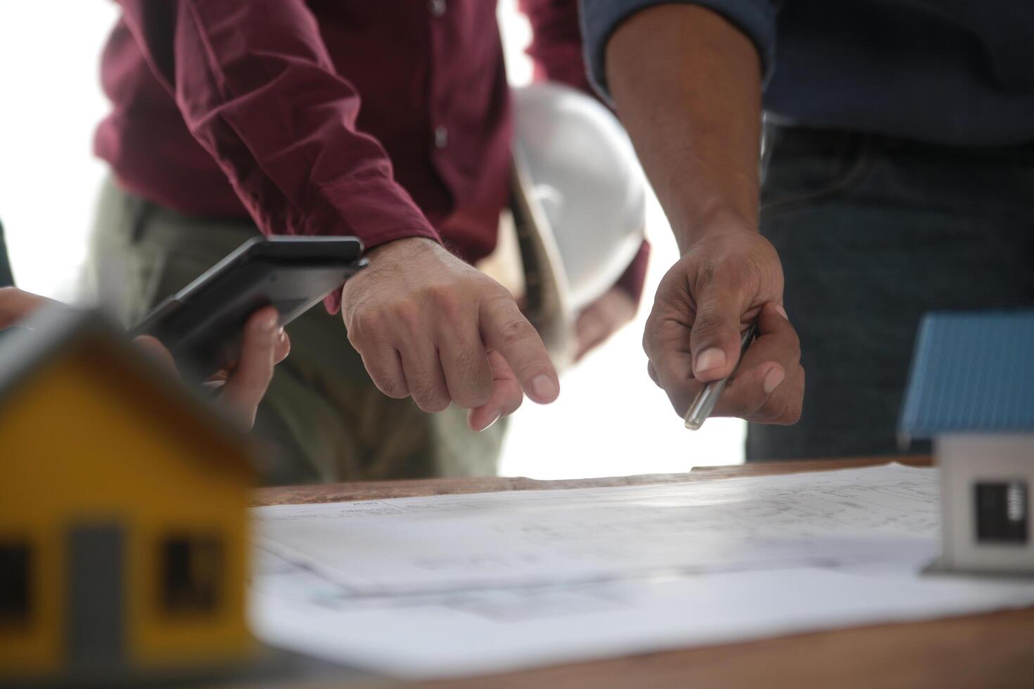 Diverse Team of Specialists Use Laptop on Construction Site. Real Estate Building Project with Engineer Investor and Businessman Checking Area, working on Civil Engineering, Discussing Strategy Plan photo