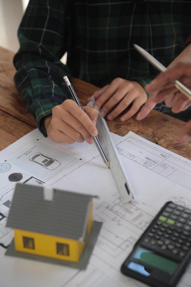 Diverse Team of Specialists Use Laptop on Construction Site. Real Estate Building Project with Engineer Investor and Businessman Checking Area, working on Civil Engineering, Discussing Strategy Plan photo