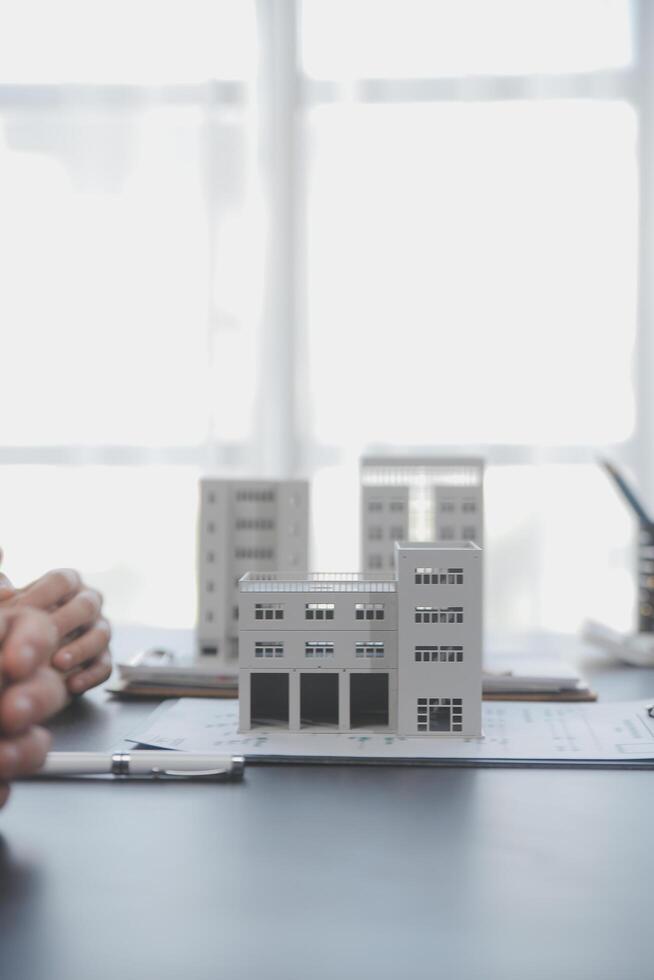 Real estate agent and Sales manager team analysis pricing of rental lease contract of sale purchase agreement, concerning mortgage loan offer for and house insurance. photo