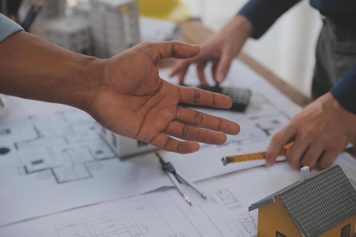 Construction and structure concept of Engineer or architect meeting for project working with partner and engineering tools on model building and blueprint in working site, contract for both companies. photo