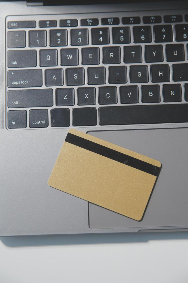 Calculator on a dark background, plastic cards and banknotes photo