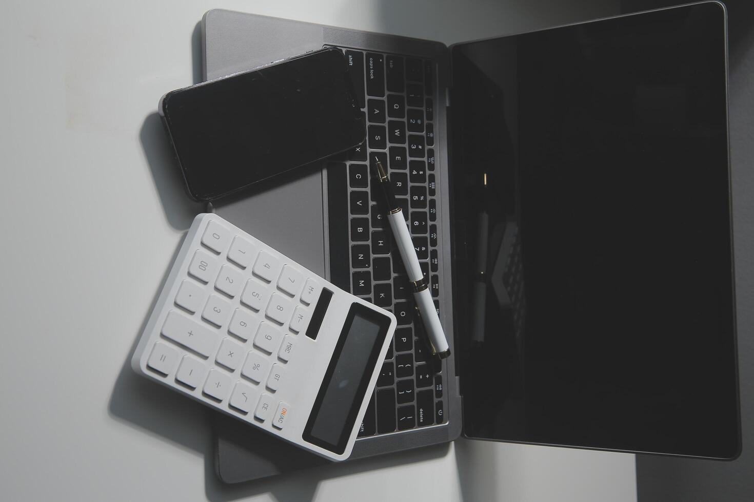 Office leather desk table with calculator and pen. Top view with copy space photo