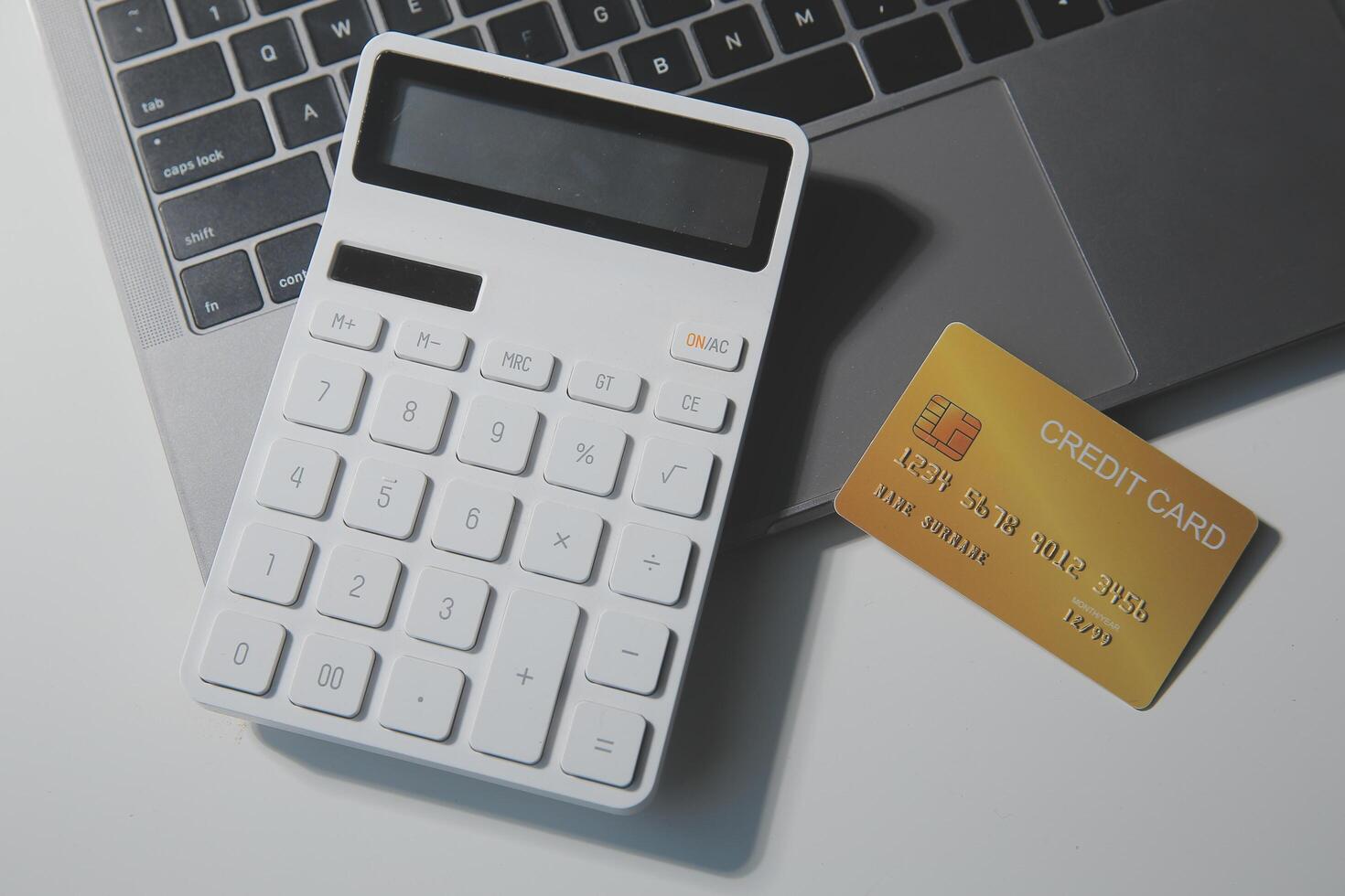 Calculator on a dark background, plastic cards and banknotes photo