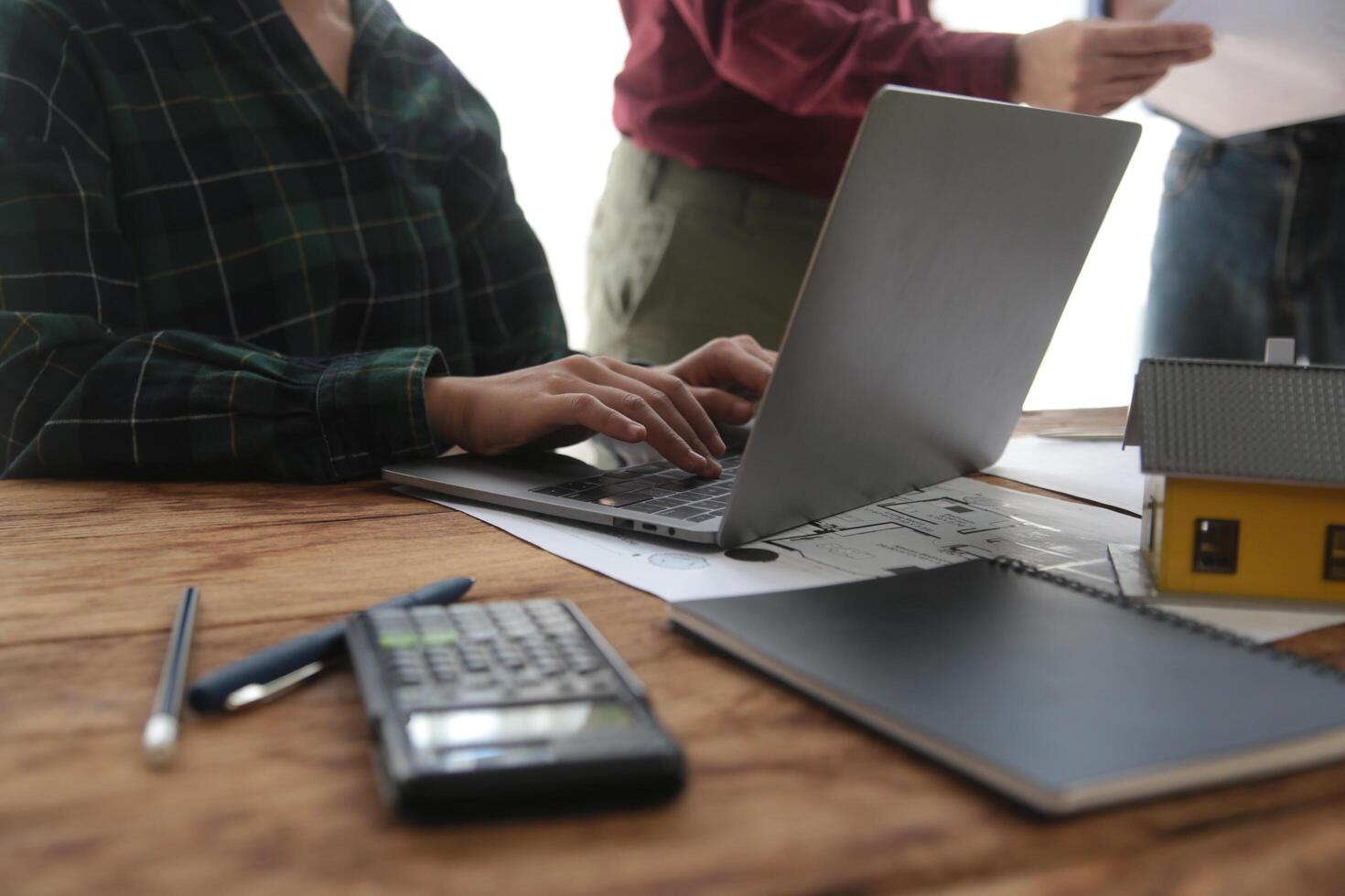 Diverse Team of Specialists Use Laptop on Construction Site. Real Estate Building Project with Engineer Investor and Businessman Checking Area, working on Civil Engineering, Discussing Strategy Plan photo