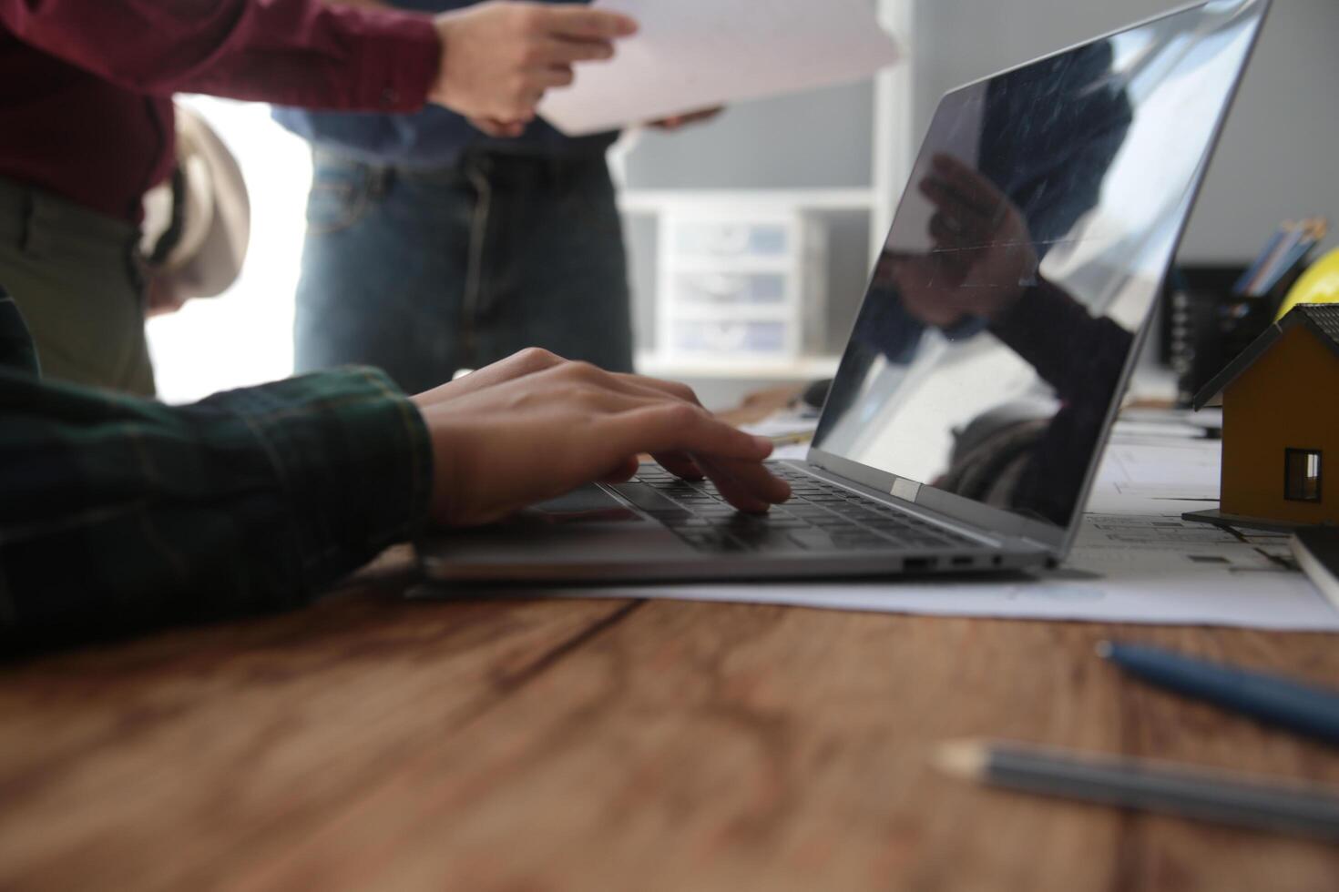 Diverse Team of Specialists Use Laptop on Construction Site. Real Estate Building Project with Engineer Investor and Businessman Checking Area, working on Civil Engineering, Discussing Strategy Plan photo