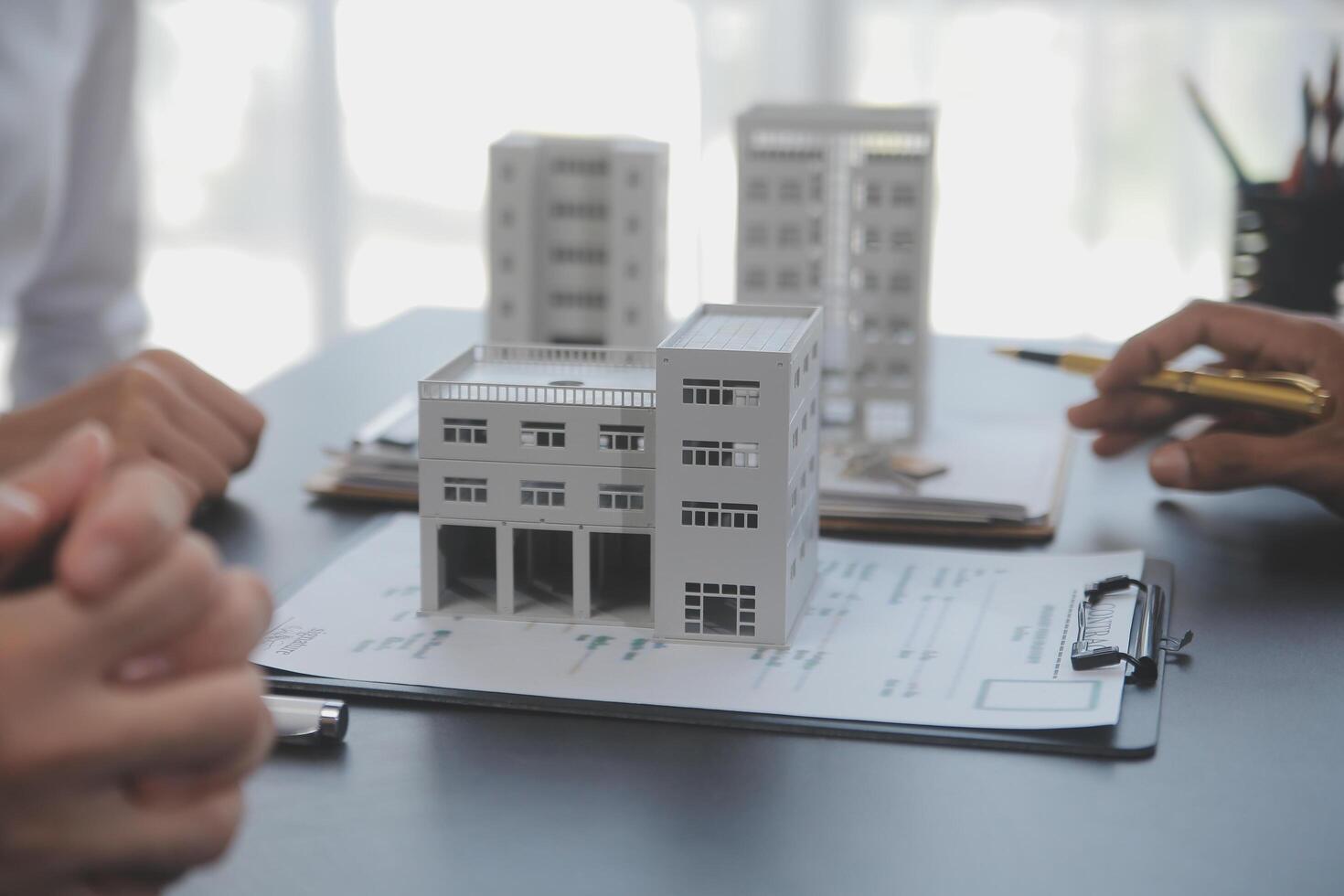 Real estate agent and Sales manager team analysis pricing of rental lease contract of sale purchase agreement, concerning mortgage loan offer for and house insurance. photo