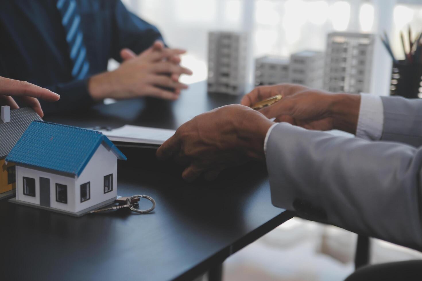 Real estate agent and Sales manager team analysis pricing of rental lease contract of sale purchase agreement, concerning mortgage loan offer for and house insurance. photo