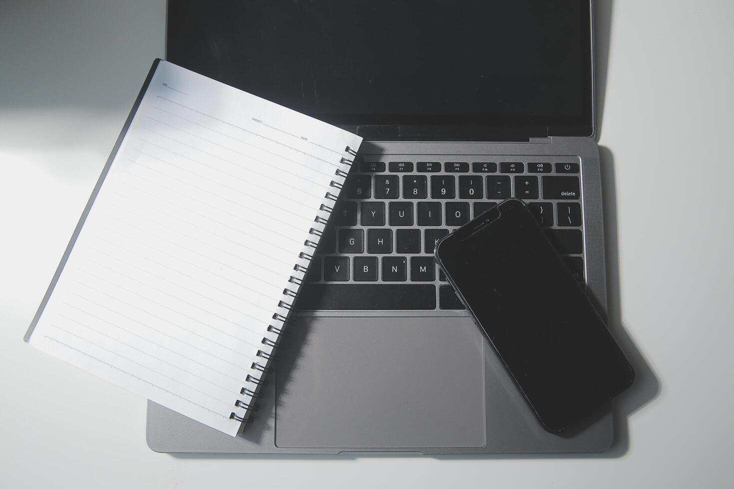 Top view of computer desk with keyboard, smartphone, stationery and coffee cup, clipping path photo