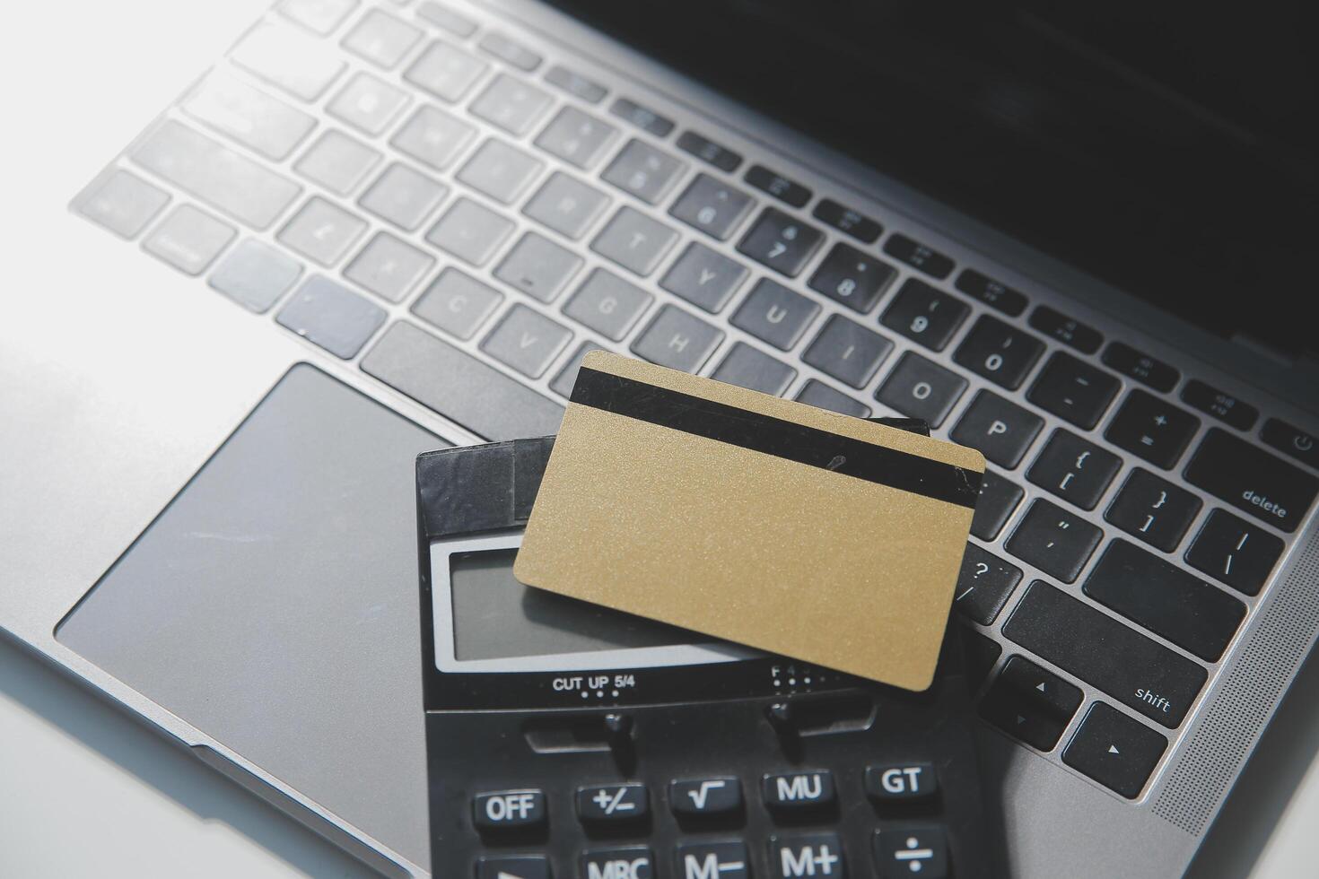 Calculator on a dark background, plastic cards and banknotes photo