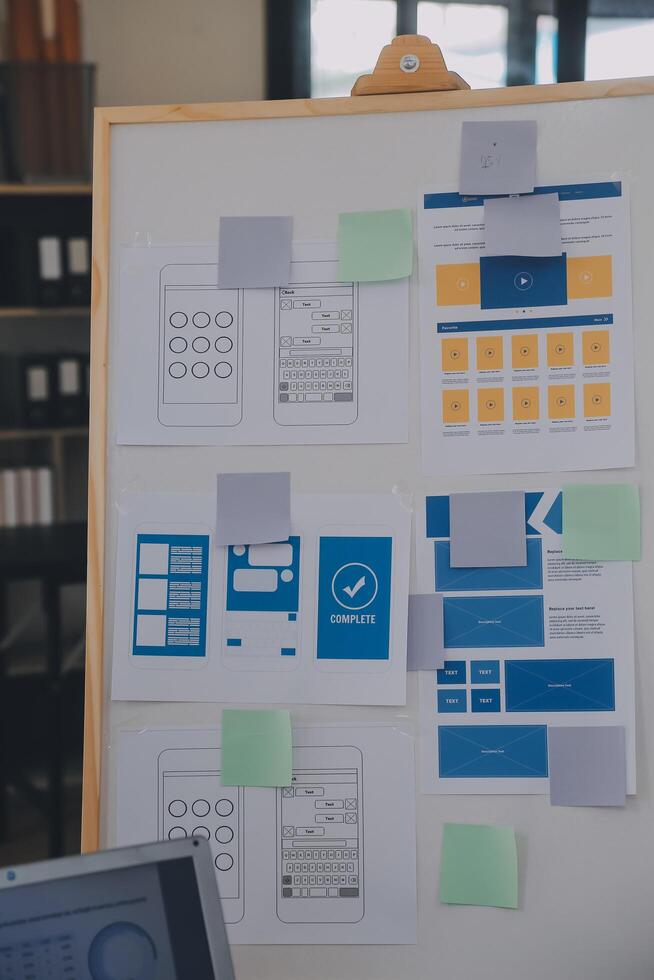 Close up ux developer and ui designer use augmented reality brainstorming about mobile app interface wireframe design on desk at modern office.Creative digital development agency photo