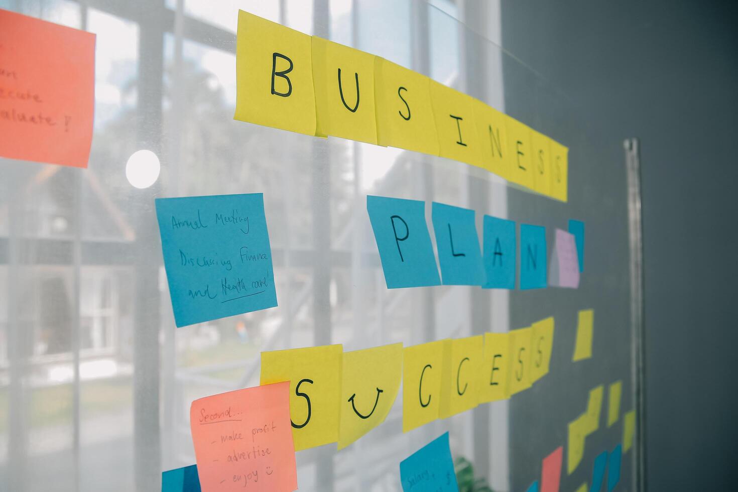 Young creative team professional using post it notes in glass wall to writing strategy business plan to development grow to success. photo