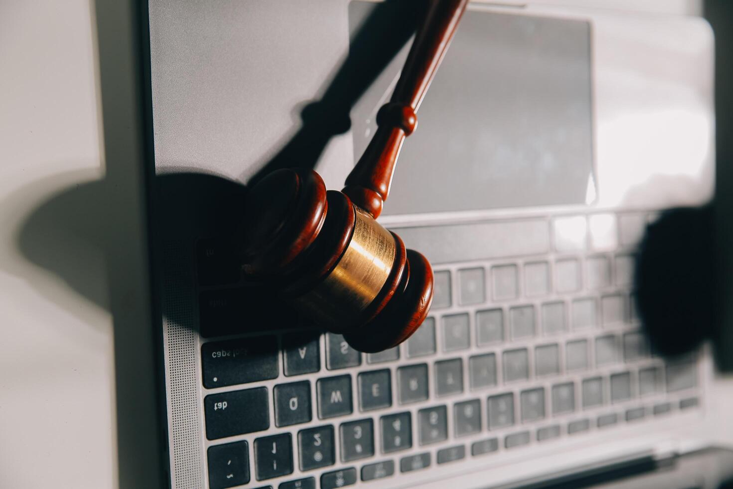 image of judge's hammer, scales lady of justice, law book, laptop computer and contract documents with pen concept of law and justice. photo
