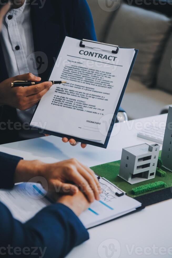 Real estate agent talked about the terms of the home purchase agreement and asked the customer to sign the documents to make the contract legally, Home sales and home insurance concept. photo