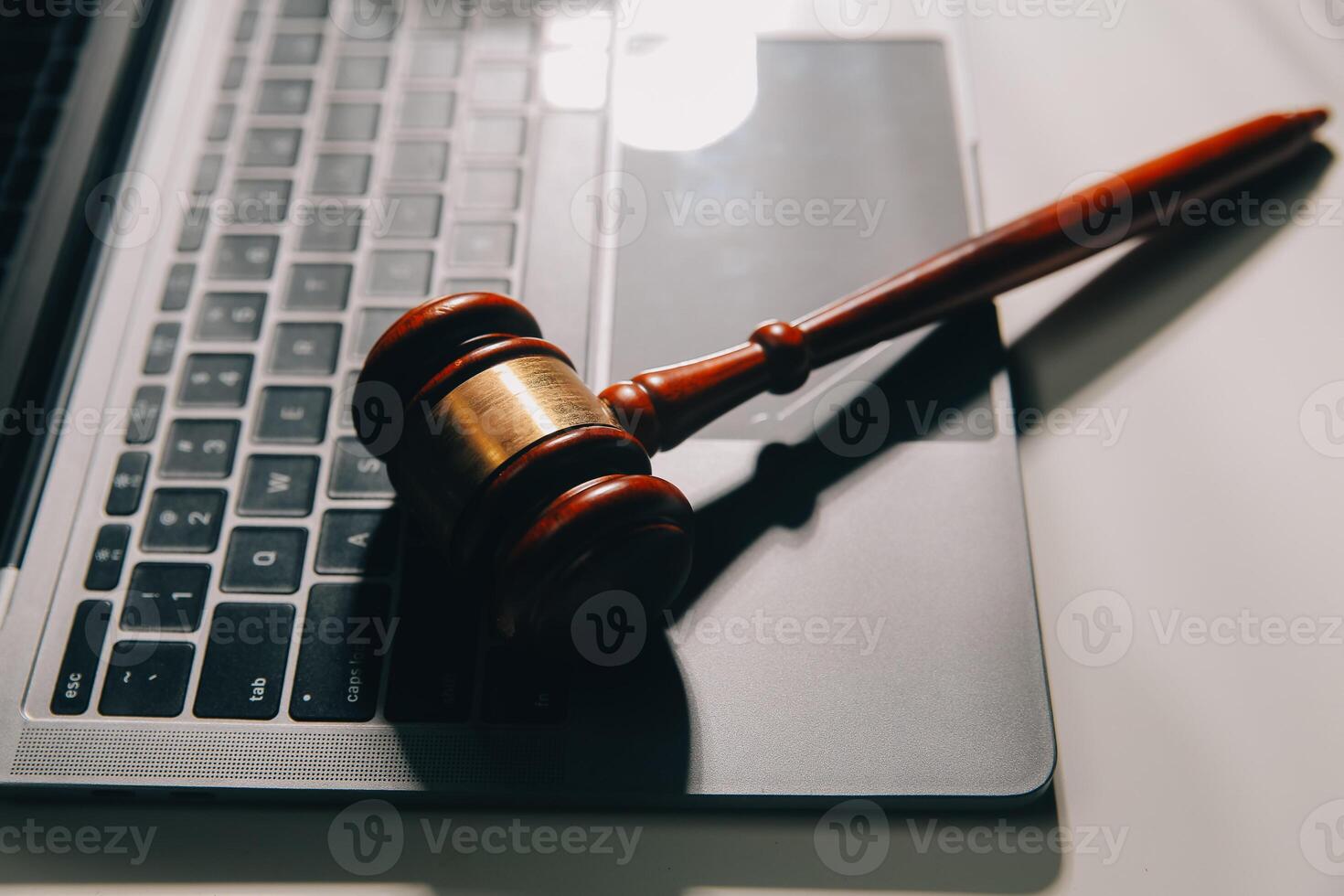image of judge's hammer, scales lady of justice, law book, laptop computer and contract documents with pen concept of law and justice. photo