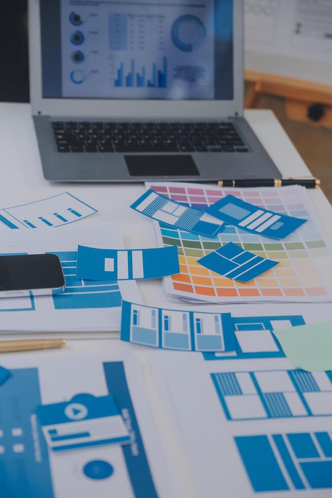 Close up ux developer and ui designer use augmented reality brainstorming about mobile app interface wireframe design on desk at modern office.Creative digital development agency photo