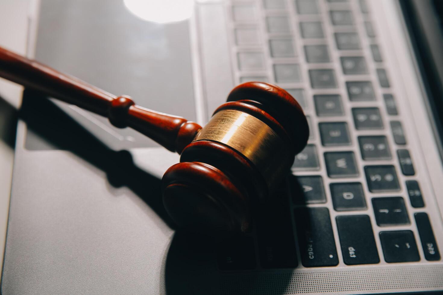 image of judge's hammer, scales lady of justice, law book, laptop computer and contract documents with pen concept of law and justice. photo