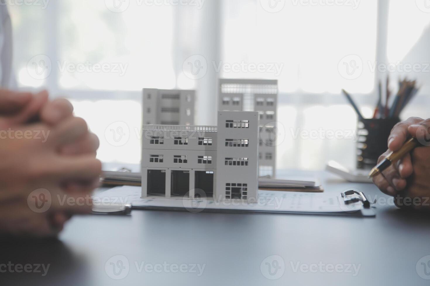 Real estate agent and Sales manager team analysis pricing of rental lease contract of sale purchase agreement, concerning mortgage loan offer for and house insurance. photo