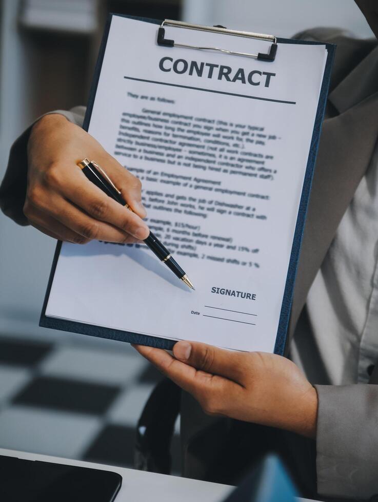 Real estate agent talked about the terms of the home purchase agreement and asked the customer to sign the documents to make the contract legally, Home sales and home insurance concept. photo