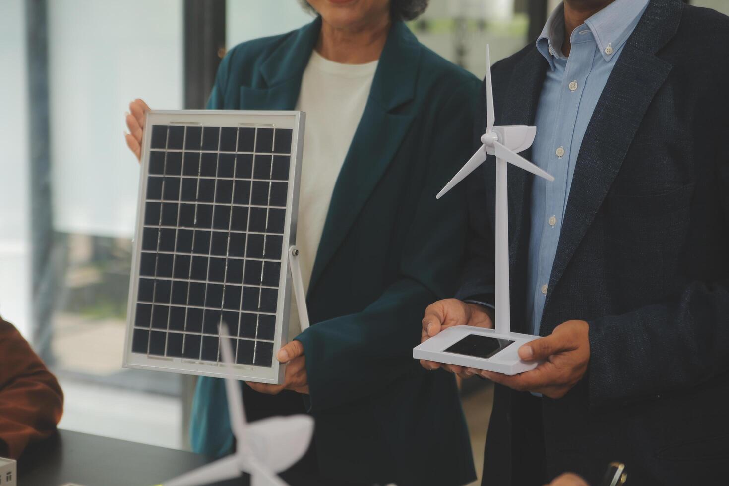 Close-up at tablet, Engineers pointing at tablet with their hands. To jointly design the use of renewable energy with wind and solar energy. Concept of using renewable energy. photo