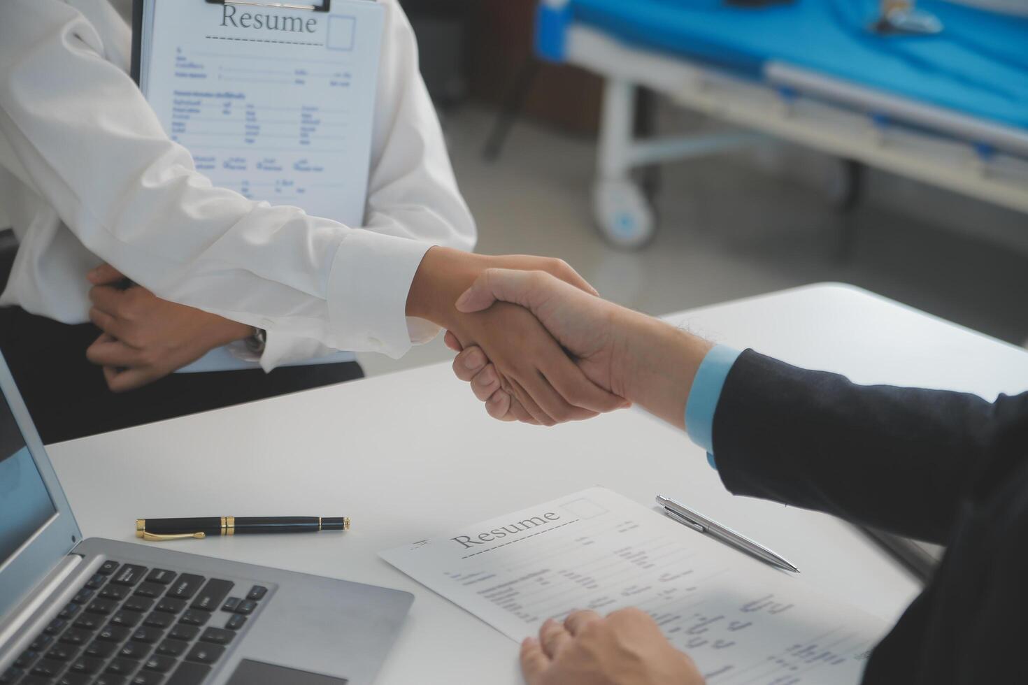 Close up view of job interview in office, focus on resume writing tips, employer reviewing good cv of prepared skilled applicant, recruiter considering application, hr manager making hiring decision photo