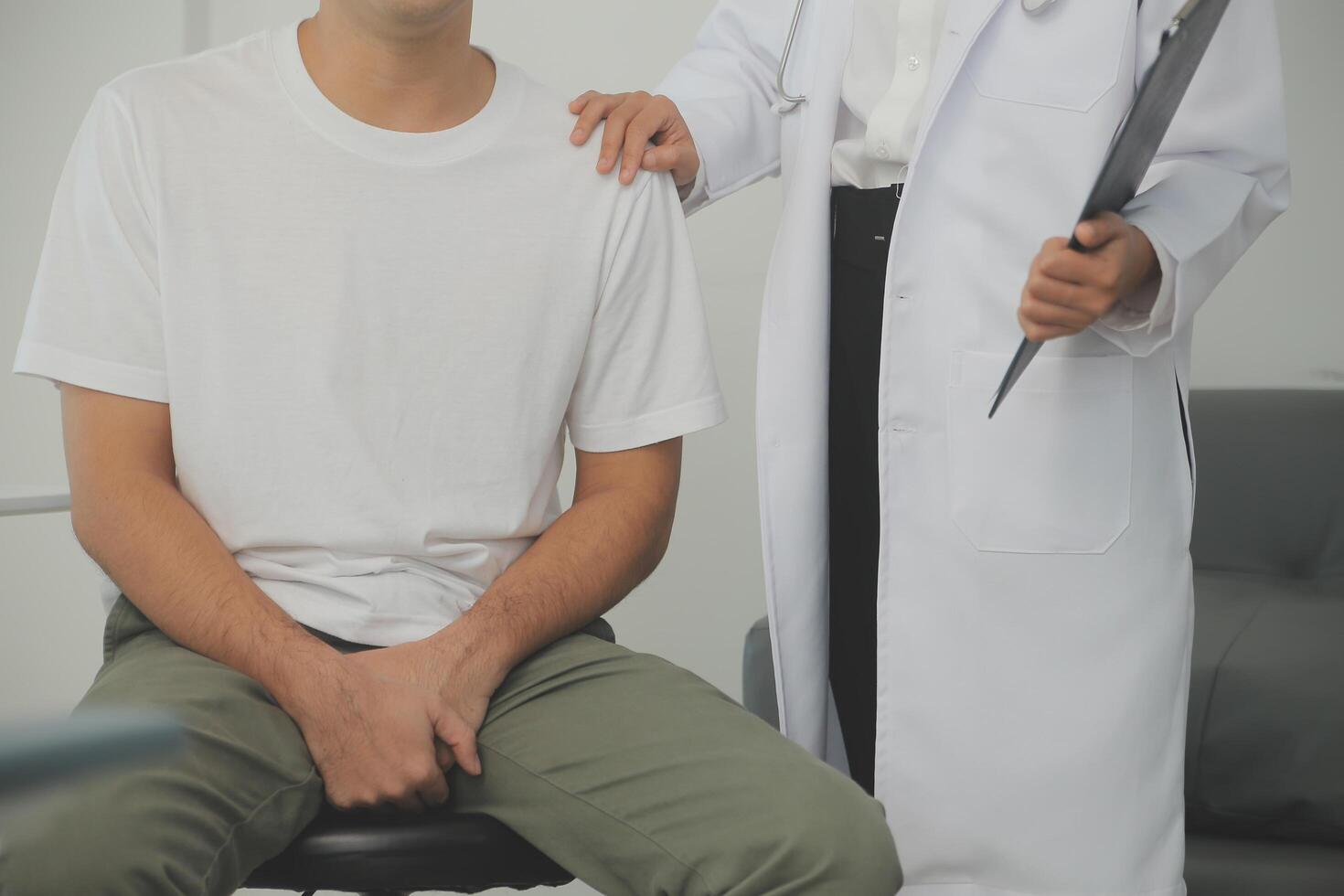 Male diseases. Man presses hands to his groin and suffering from pain, panorama, cropped, studio shot photo