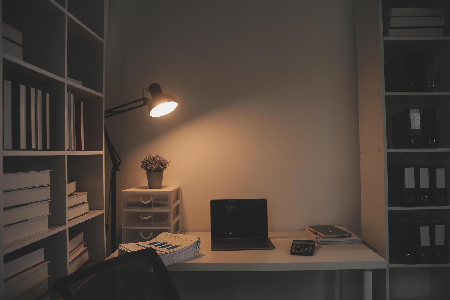 Laptop and paperwork on conference table photo