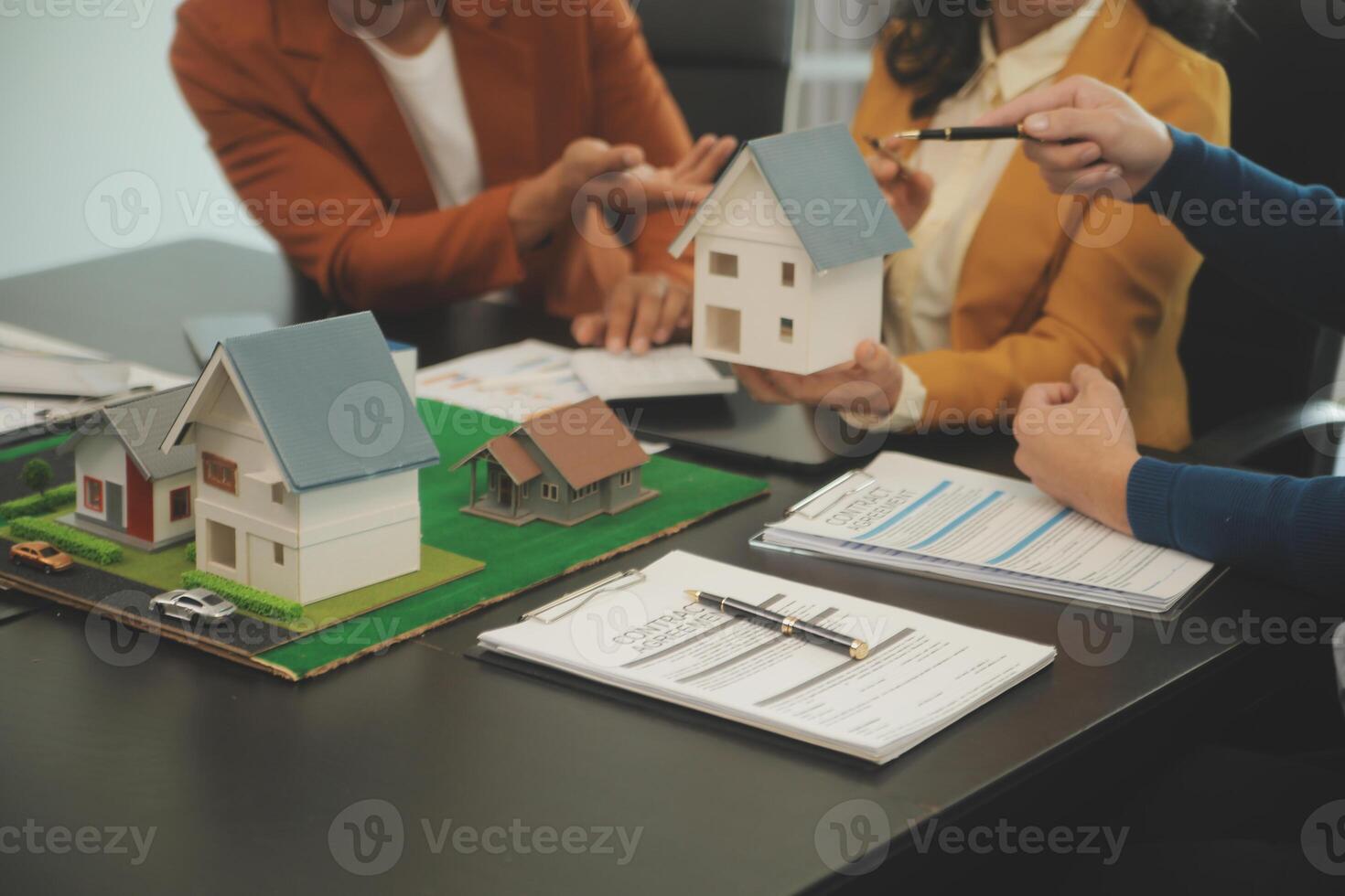 Team of architectures and businessmen discussing and brainstorming on floor plan modification for real estate investment and housing development project photo