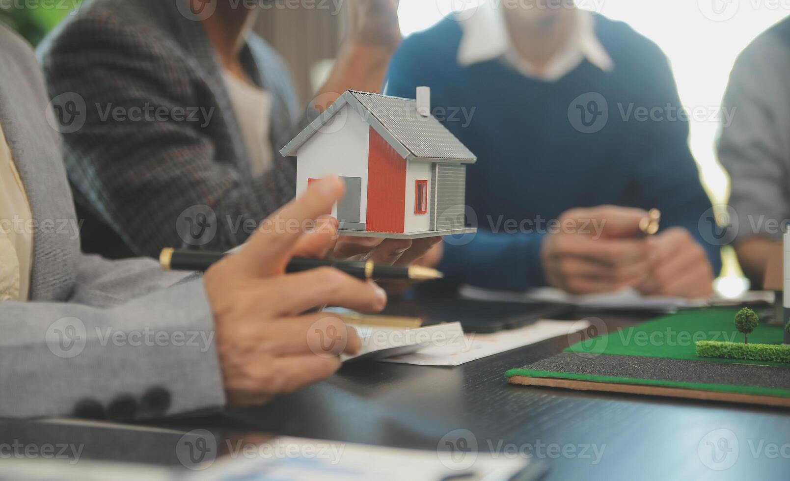 Team of architectures and businessmen discussing and brainstorming on floor plan modification for real estate investment and housing development project photo