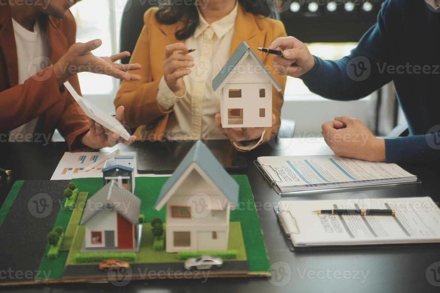 Team of architectures and businessmen discussing and brainstorming on floor plan modification for real estate investment and housing development project photo
