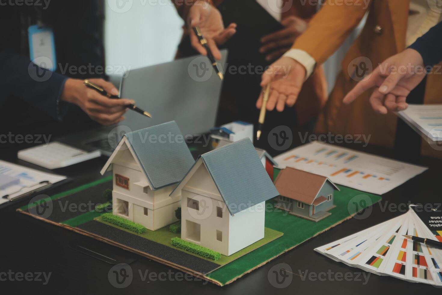 Team of architectures and businessmen discussing and brainstorming on floor plan modification for real estate investment and housing development project photo