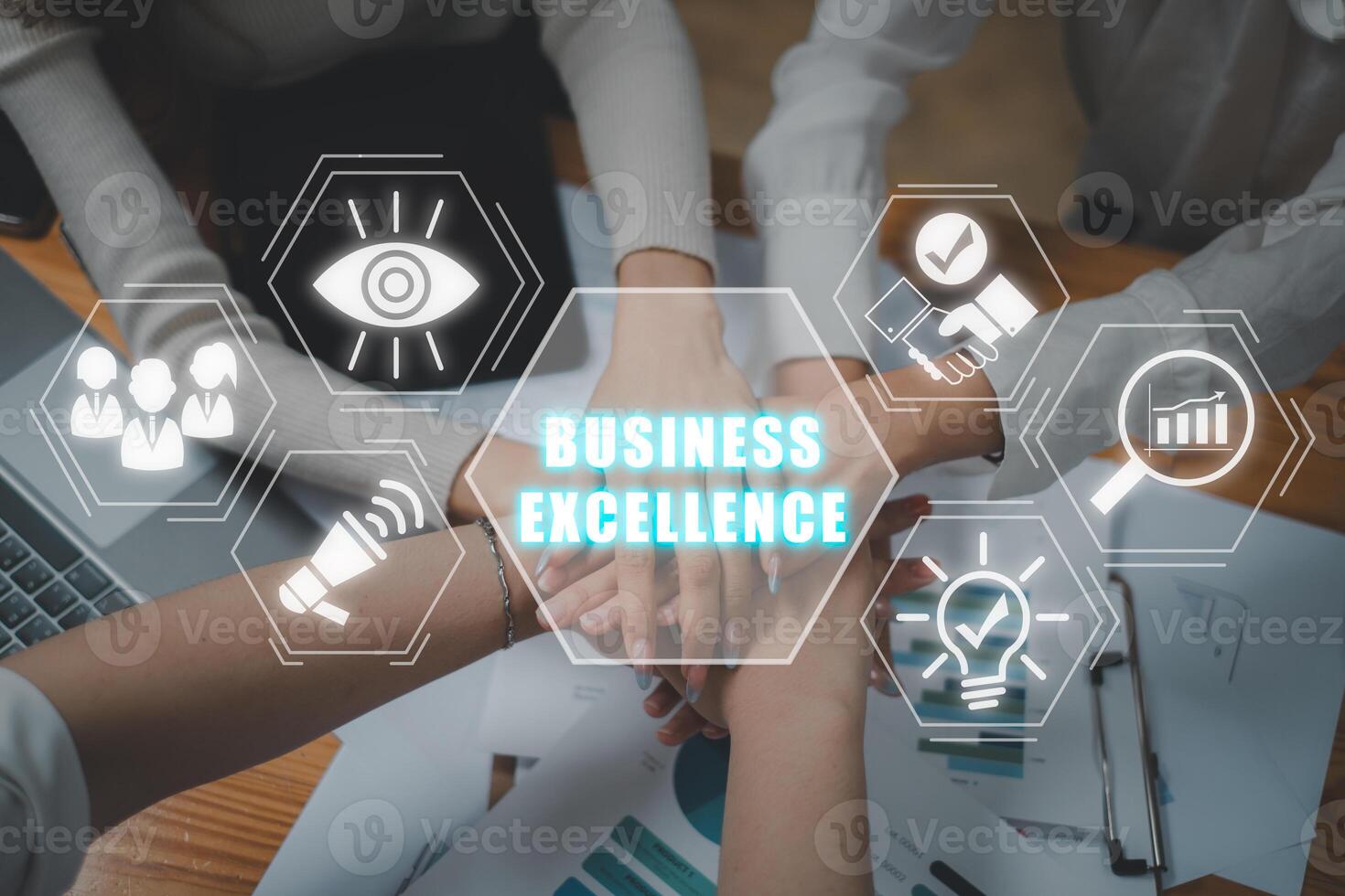Business excellence concept, Positive diverse business team putting their hands on top of each other with business excellence icon on virtual screen. photo
