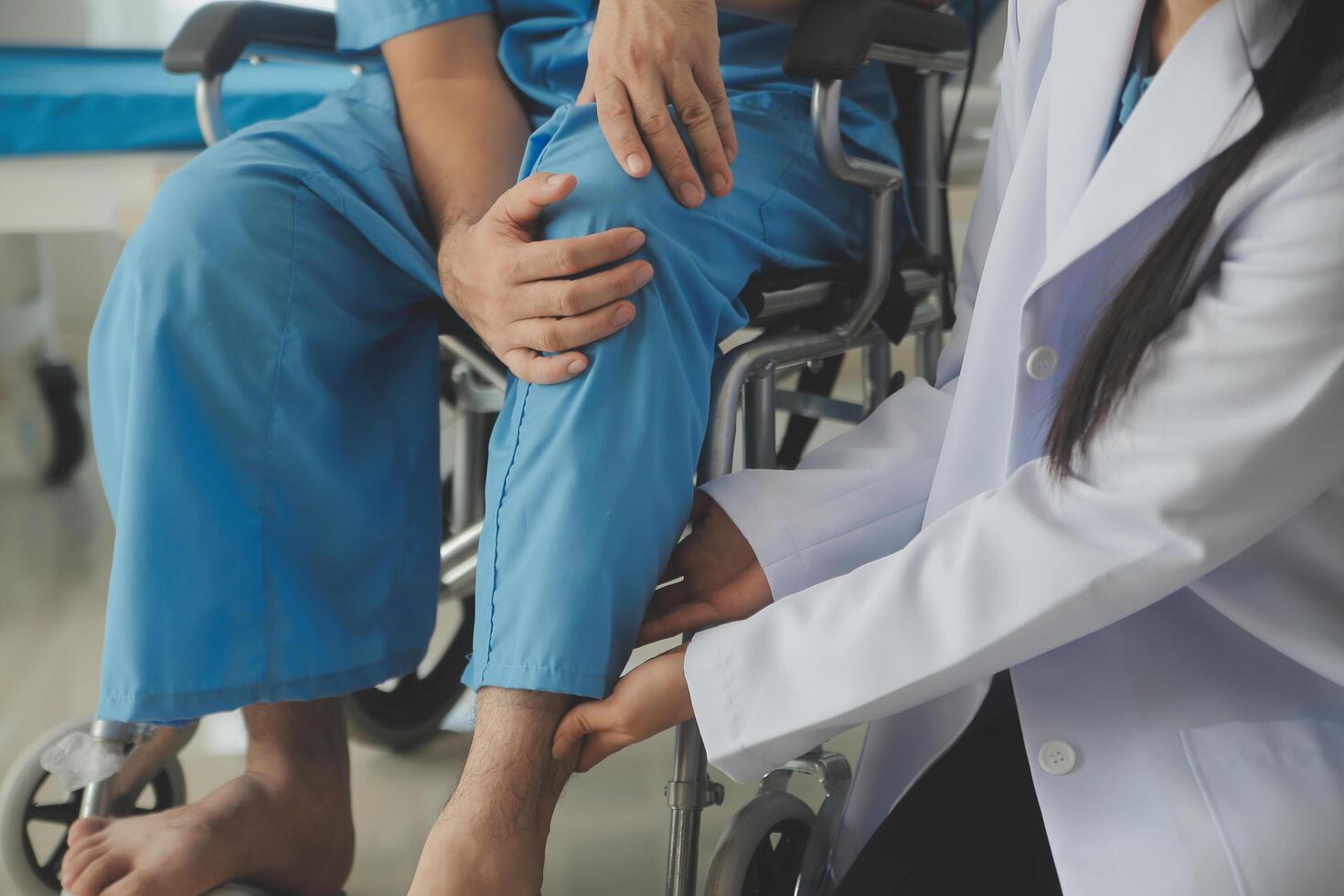 young asian physical therapist working with senior woman on walking with a walker photo