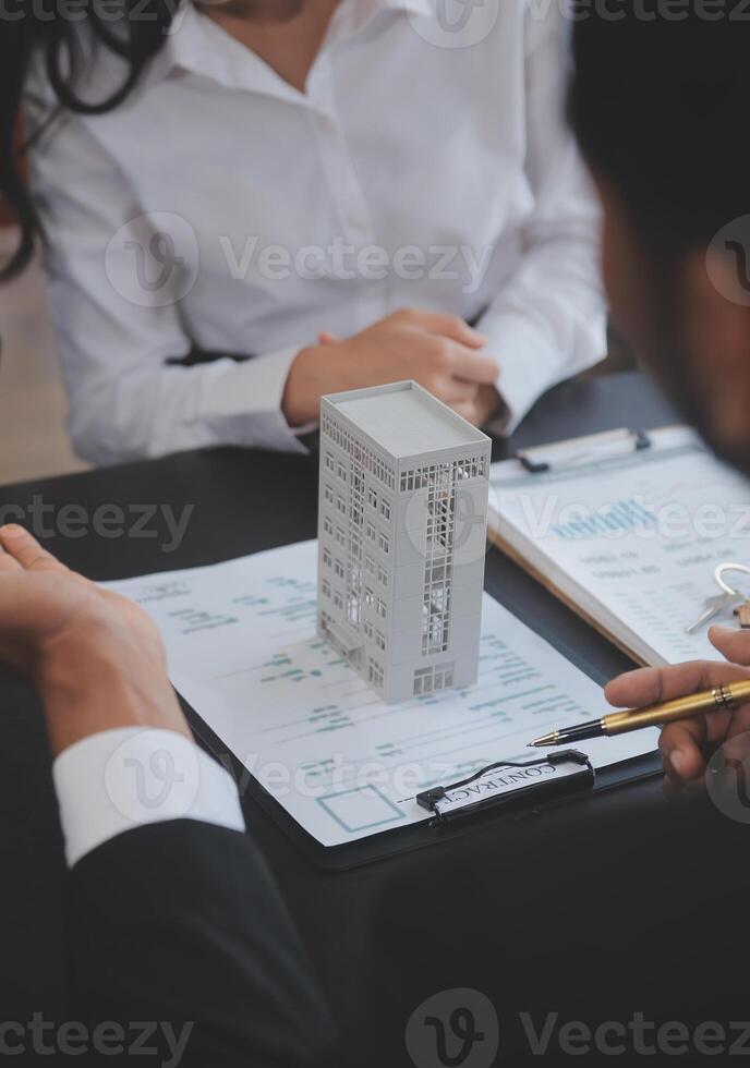 Real estate agent and Sales manager team analysis pricing of rental lease contract of sale purchase agreement, concerning mortgage loan offer for and house insurance. photo