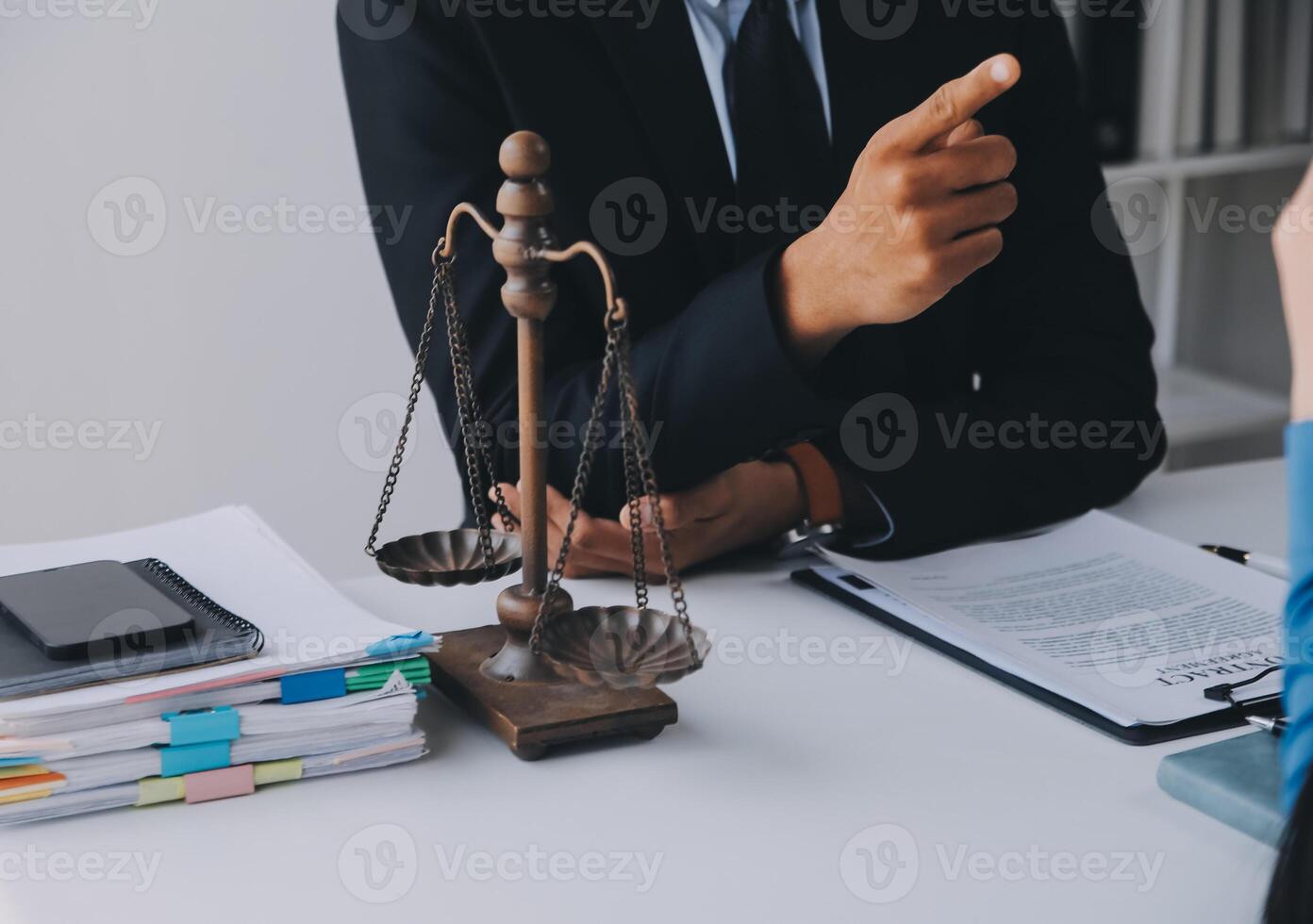 Justice and Law concept. Legal counsel presents to the client a signed contract with gavel and legal law or legal having team meeting at law firm in background photo